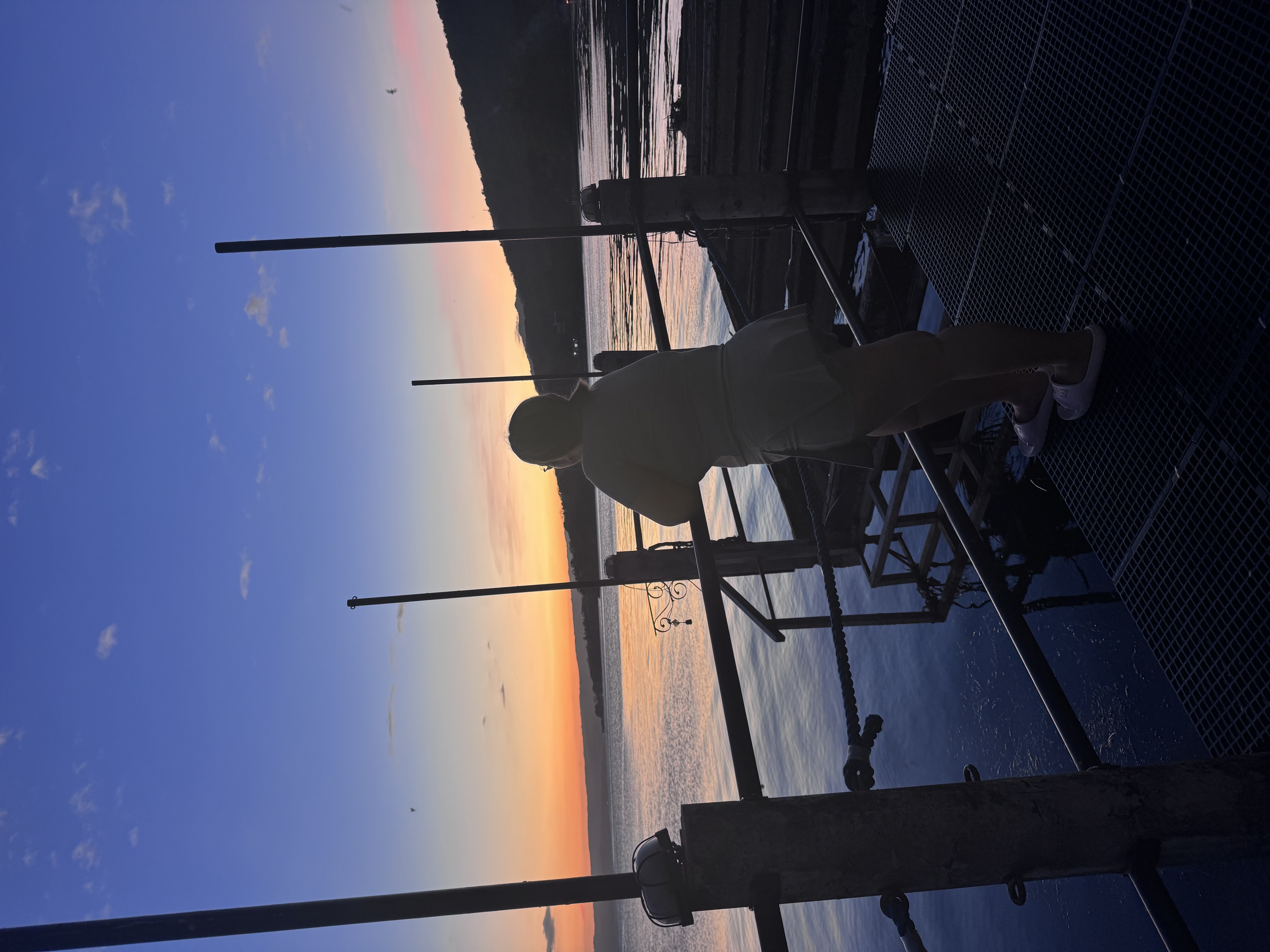Jane watching a sunset at a pier